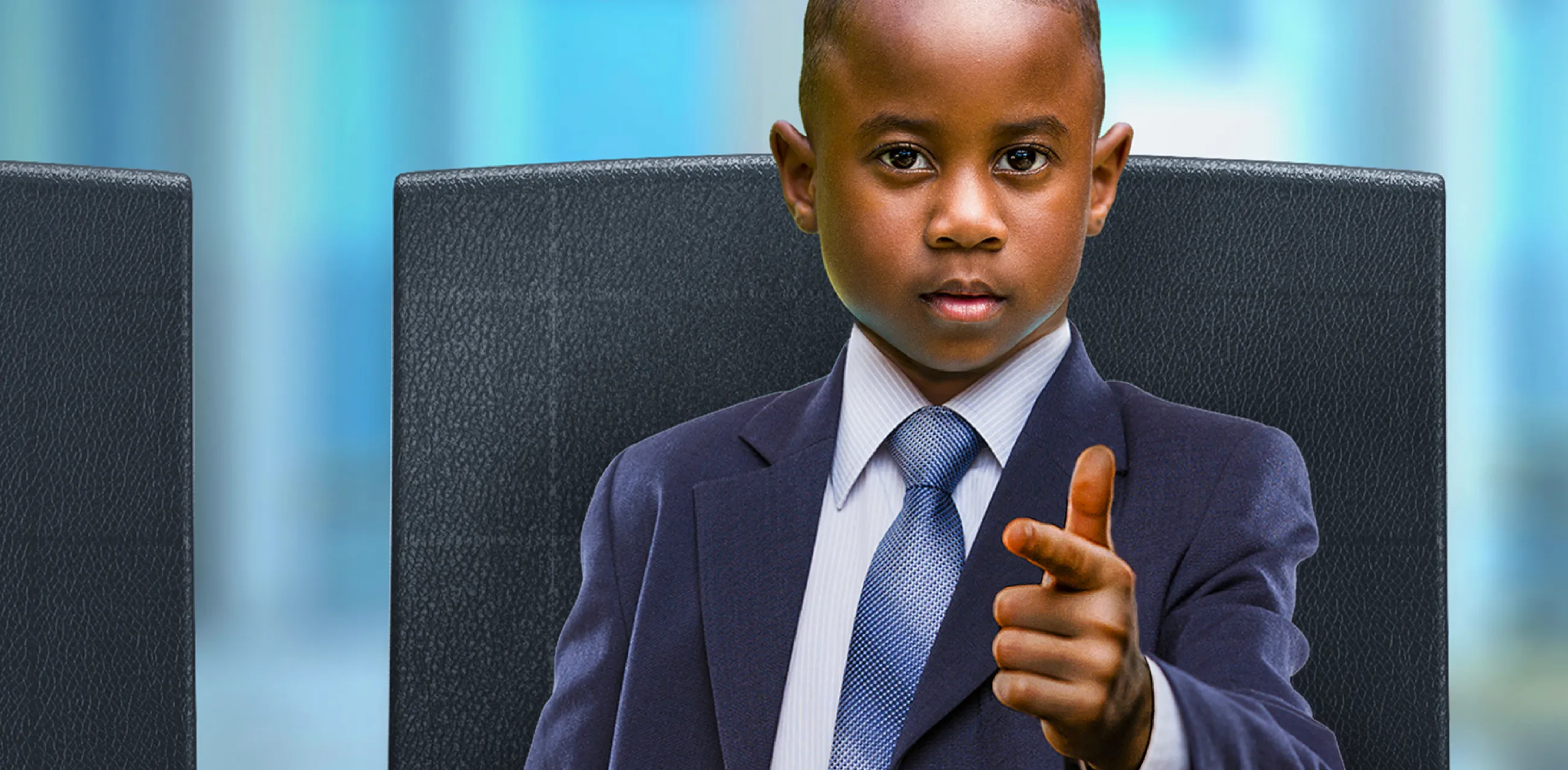 Teach First "Challenge the Impossible" campaign visuals showing a young boy dressed as an entrepreneur in a business suit, pointing at the viewer.